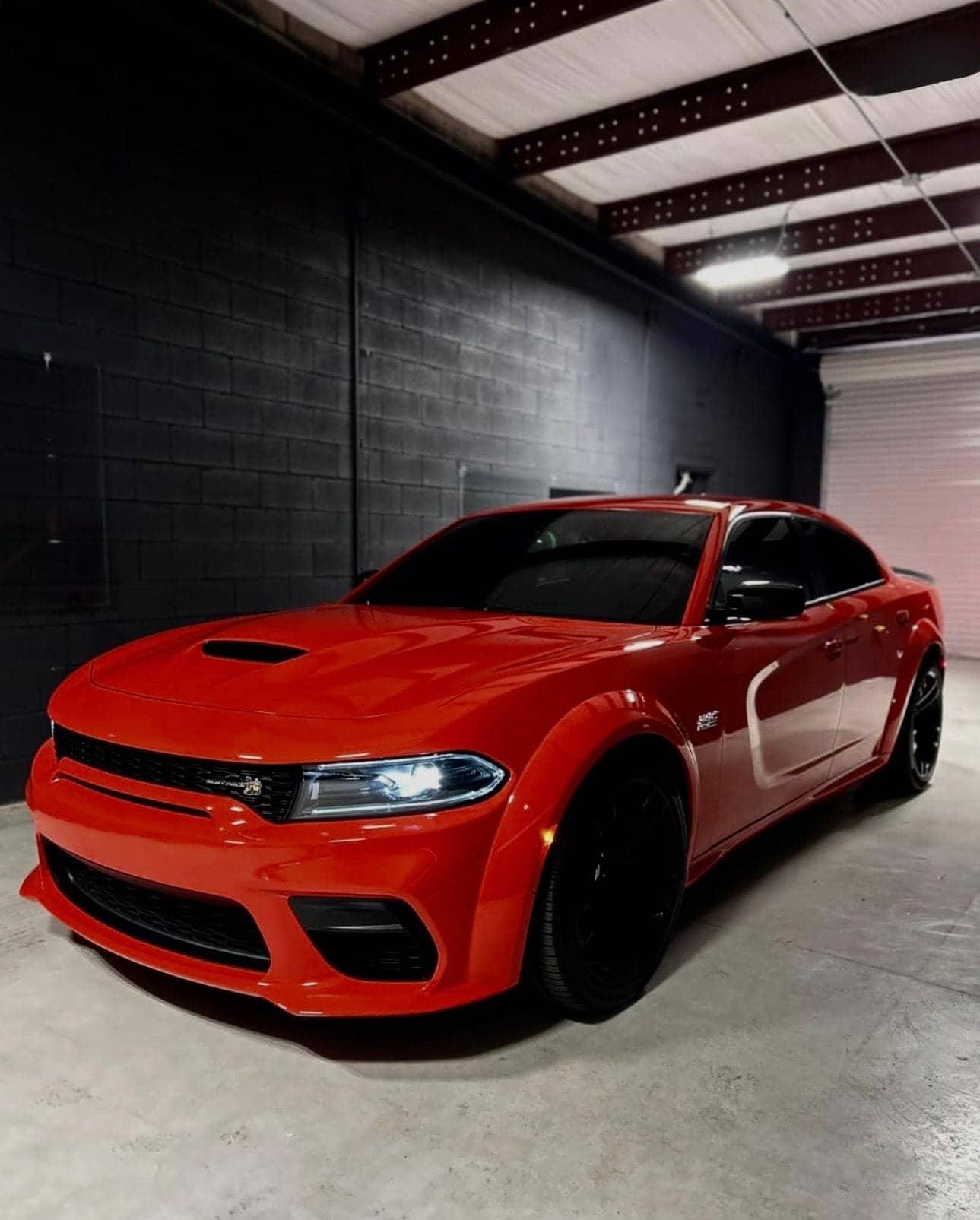 Red Dodge Charger with tinted windows in the studio